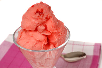 glass of cherry sherbet on a red and white napkin