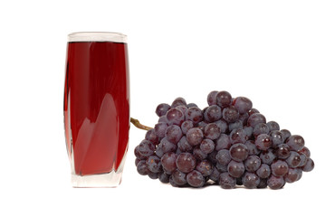 a glass of grape juice with a cluster of grapes