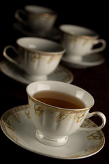 four porcelain cups with drink
