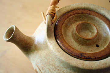 small brown stoneware teapot with bamboo handle