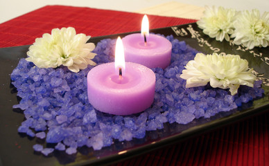 Fototapeta na wymiar spa essentials (violet salt, candles and flowers)