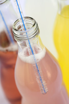 bottles of soda with straw