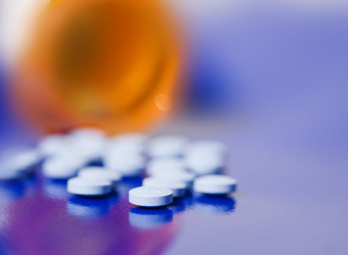 bottle of pills on blue background,