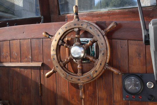 old boat wheel and a knots meter.