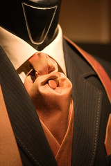 brown tie and black suit on shop mannequins