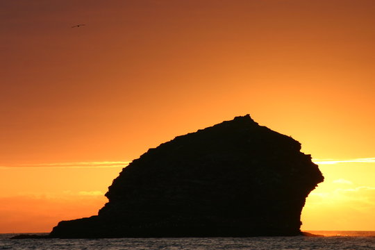 the sunset eclipsed by gull rock, portreath, cornw