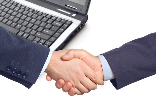 business handshake  with a laptop