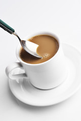 stirring a cup of coffee