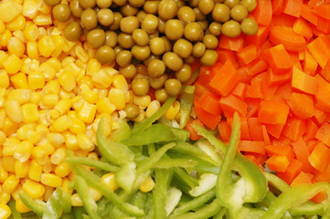 close up of salad with corn, carrots, peppers and peas