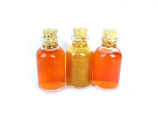 three glass bottles orange yellow