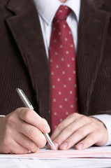 businessman signing documents