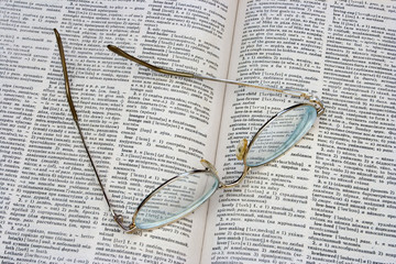 glasses on opened book