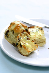 Warm hot cross buns with melted butter