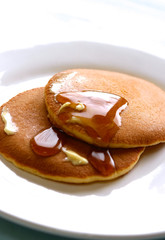 two pieces of pancakes served with maple syrup