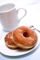 two delicious sugared ring donuts