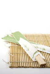 chopsticks on sushi rolling mat