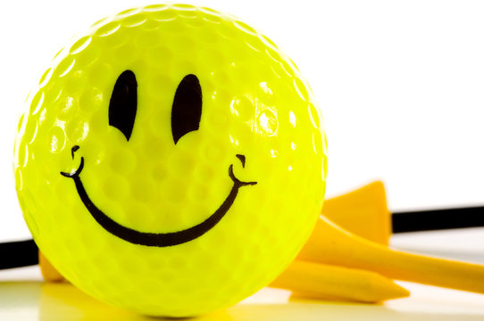 Smiley Face Golf Ball On White Background