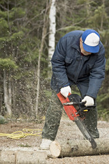 senior using his chain saw