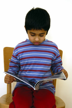 Kid Reading A Magazine