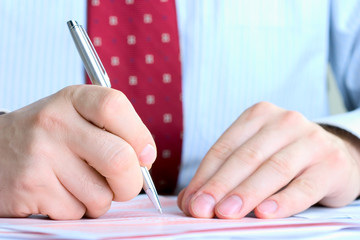 businessman signing documents