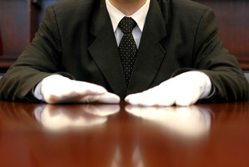 businessman with white gloves speaking