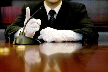 businessman with white gloves speaking