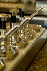 syrup dispensers lined up at a trendy coffee shop