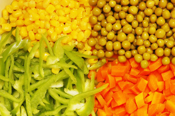 close up of salad with corn, carrots, peppers and peas