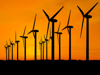 wind generators over orange sky