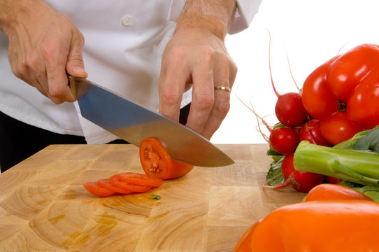 professional chef slicing tomato