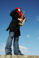 Naklejka premium girl plays on a saxophon