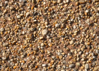 close up of stones stuck to a wall.