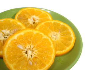 pieces of orange on green dish isolated