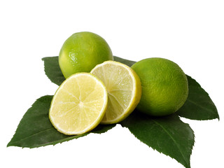 green limes on leaves over white background
