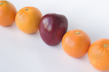 apple in the middle of oranges