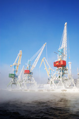 harbour cranes shrouded by a fog