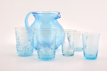 set of blue glasses and water pitcher