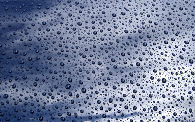 close up of raindrops on a car bonnet.