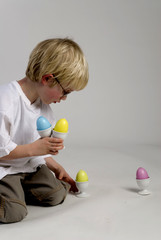 Fototapeta na wymiar boy is playing with easter eggs