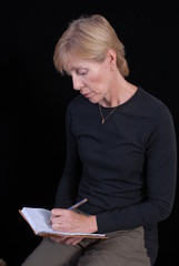 woman writing in book