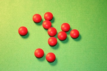 red pills on green background