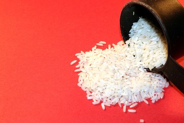 rice spilled on red background
