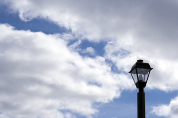 street light against the blue cloudy sky