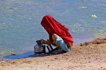 india, rajasthan, thar desert: woman searching water in a very p