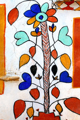 india, rajasthan, jaisalmer: colourful painted walls in the vill
