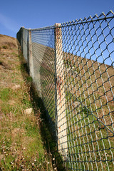 close view of a ong fence up a steep hill