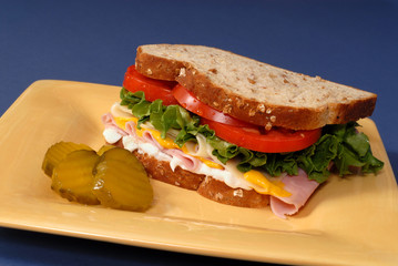 ham, cheese, lettuce and tomato sandwich with pickles