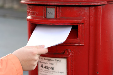 posting letter to red british postbox - 2610891