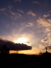 stone cross in sunset