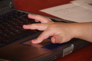 child working on laptop